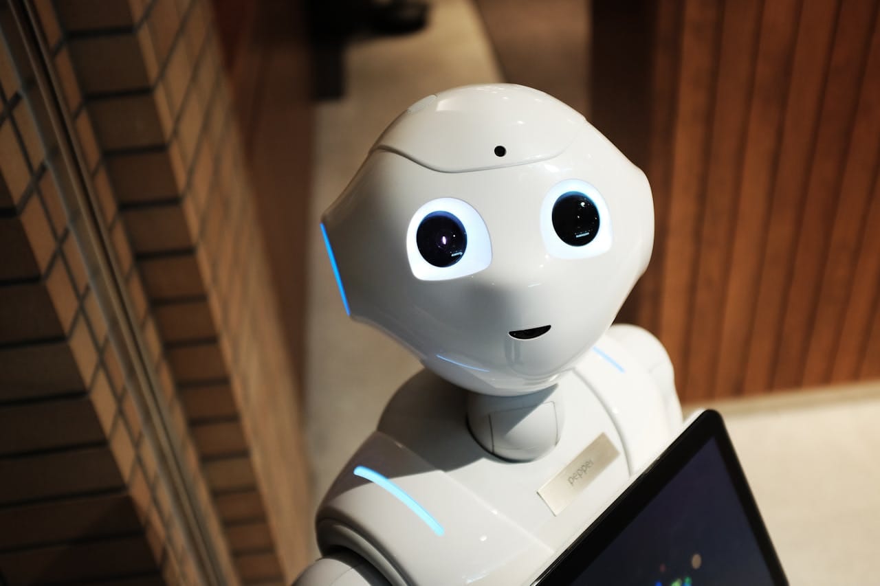 hero-img-01 A futuristic humanoid robot in an indoor Tokyo setting, showcasing modern technology.